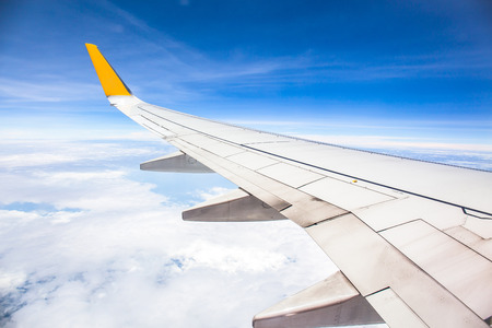 viewpoint Wing of windows airplane flying above the clouds in the skyの写真素材