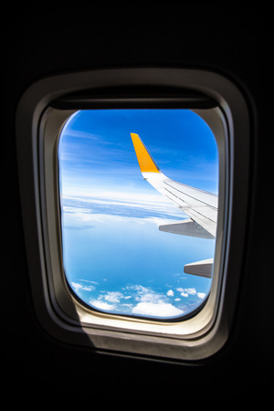 viewpoint Wing of windows airplane flying above the clouds in the skyの写真素材