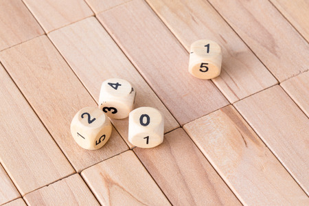 wooden dices on wood floorの写真素材