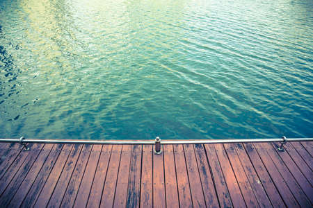 vintage tone of Wood floors for a stroll at the pool water blue.の写真素材