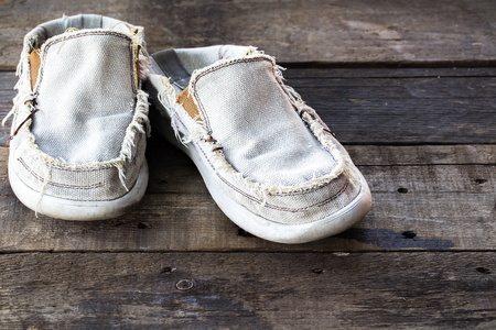 vintage Dirty gym old shoes on wooden backgroundの写真素材