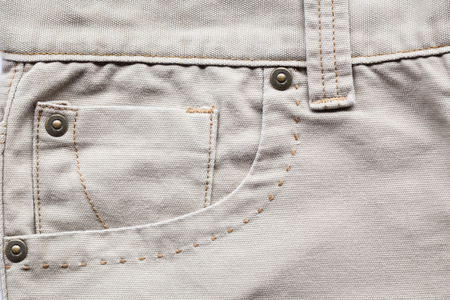 back pocket on brown denim background