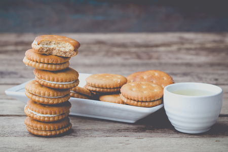 vintage soft tone of cookies bread and a Teacup on wooden table. Menu set for afternoon snack.の写真素材