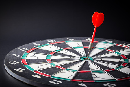Dart board is the target and goal. Success hitting target aim goal achievement. financial concept with goal money.の写真素材