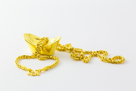 chinese ancient gold bullion nugget and necklace on white background.の写真素材