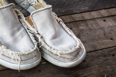 vintage Dirty gym old shoes on wooden backgroundの写真素材