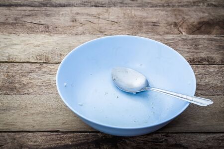 Empty dish after eat food on the wooden tableの写真素材