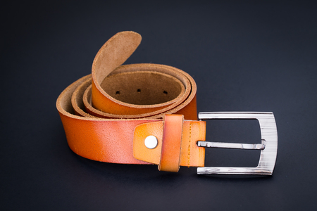 brown leather belt for men on black backgroundの写真素材