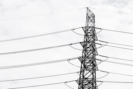 High voltage transmission tower with clouds. electricity post color tool for black and white tone.の写真素材
