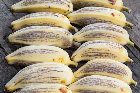 ripe bananas on a wooden tableの写真素材