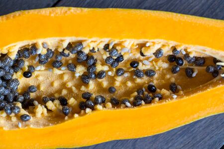 papaya slices isolated on wooden backgroundの写真素材