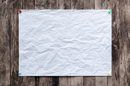 crumpled paper, paper background on old wooden with Sticky pin.の写真素材
