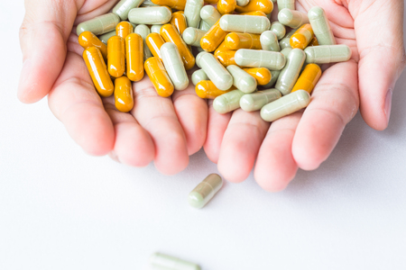 Herb capsule on handsの写真素材