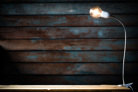abstract Old wooden backdrop with Tungsten filament lamps on wooden floor.の写真素材