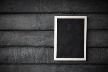 empty Blank chalkboard in wooden frame isolated on wooden backgroundの写真素材