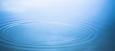 Abstract water concentric radial wave for backdrop. Droplet drops on the water surface for background.の写真素材