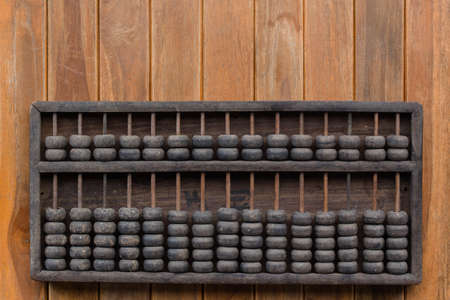 Old Vintage tone of Man's hands accounting with old abacus and hold electronic calculator. picture financial concept design.の写真素材