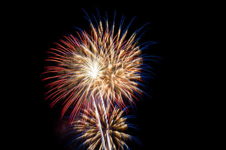 Fireworks of various colours on black background. New Year celebration colourful fireworks.の写真素材