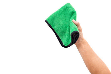 Abstract male hand holding green microfiber cleaning cloth on white. Background copy space for add text or art work design.の写真素材