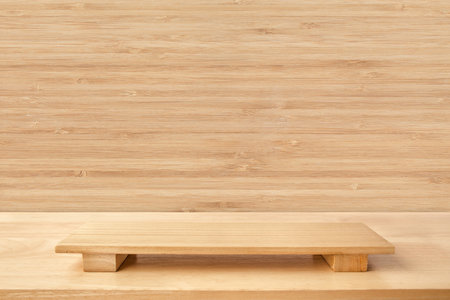 Empty sushi board on wood table with bamboo background. Top view of plank wood for graphic stand product, interior design or montage display your product.の写真素材