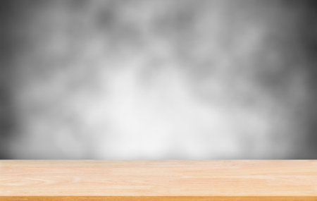 Abstract Natural wood table with blurred photo backdrop concrete grunge paint wall background. Top view of plank wood for graphic stand product, interior design or montage display your productの写真素材