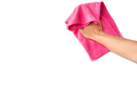 Abstract male hand holding pink microfiber cleaning cloth on white. Background copy space for add text or art work design.の写真素材