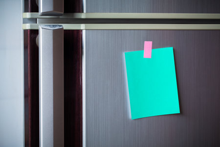 Empty paper sheet on refrigerator door. Note paper with magnetic. Valentine send text love message. Memory day note story everyday.の写真素材