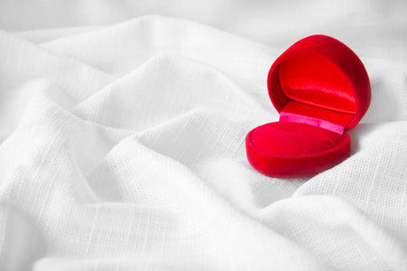 Abstract Red Velvet heart box for engagement ring on fabric linen texture for design. Valentine...