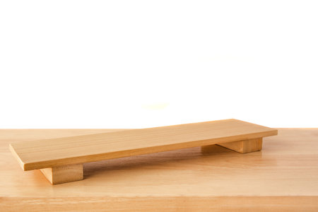 Empty sushi board on wood table with white background. Top view of plank wood for graphic stand product, interior design or montage display your productの写真素材