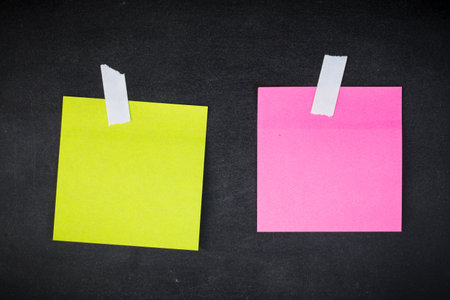 paper note on black board. blank notes. sticker note empty space for add text.