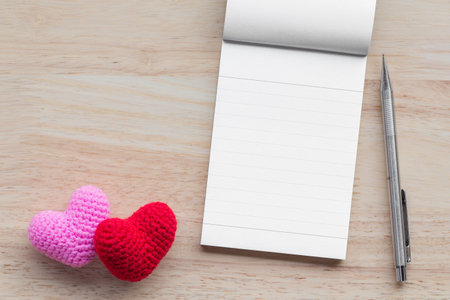 Back to school concept. Open book on table with blackboard backdrop copy space for art work design or add text message.の写真素材