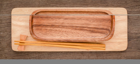 Empty sushi bamboo tray board on wood table white background. Bamboo products that have been processed into trays for use in the kitchen. Top view of plank wood for graphic stand design product.の写真素材