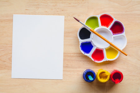Top view of paintbrushes palette and watercolor paints with white paper. picture with copy space and for add text message..の写真素材