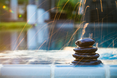 Spa background. Still life with water drops and zen black stone on serenity swimming pool