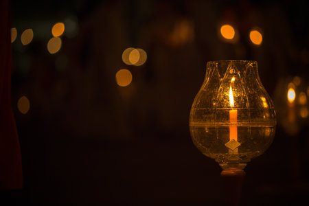 candle in glass lantern at the night. Buddha candle. Image has shallow depth of field.の写真素材