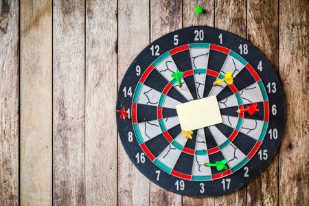 Business concept. darts arrows in the target center with paper note for Writing goals for this business yearの写真素材