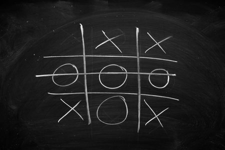 Abstract Tic Tac Toe Game Competition. XO Win Challecge Concept on black boardの写真素材