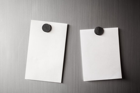 Empty paper sheet on refrigerator door with magnetic clip paper note for add text message.の写真素材