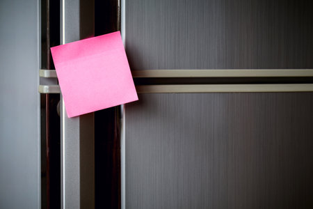Empty paper sheet on refrigerator door with magnetic clip paper note for add text message.の写真素材