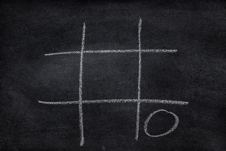 Abstract Tic Tac Toe Game Competition. XO Win Challecge Concept on black boardの写真素材