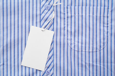 business man shirt form or formal blue shirt in a checked blue pattern with blank white label or tag attachedの写真素材