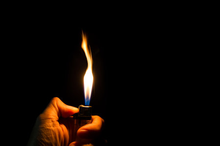 abstract blur Motion Hand with lighter igniting sparks on dark backgroundの写真素材
