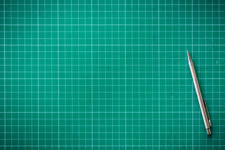 Plastic green cutting mat texture. squared sheet texture green backgroundの写真素材