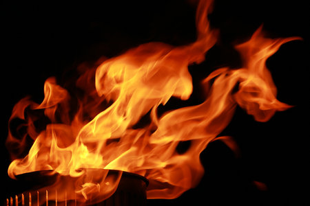 Abstract fire flames from torch, isolated on black backgroundの写真素材