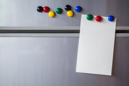 Empty paper sheet on refrigerator door. Note paper with magnetic.の写真素材