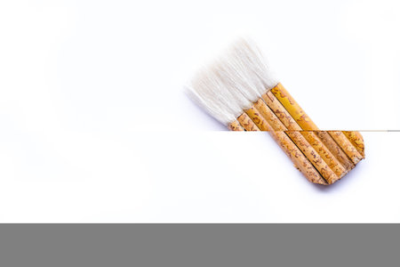 brown paint wood brush isolated on a white backgroundの写真素材