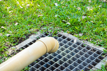 Steel drain out in the lawn outdoor with green grass.の写真素材