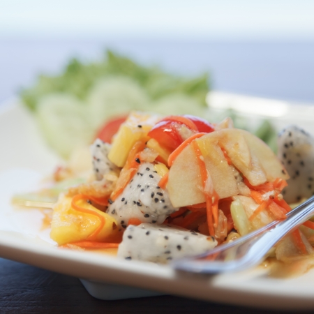 Spicy mixed fruits salad on the white plateの写真素材