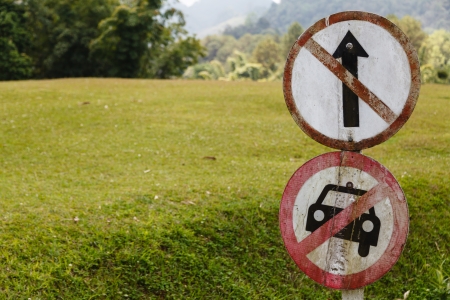 Traffic sign in front of the green fieldの写真素材