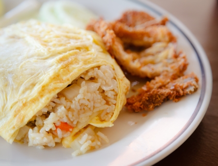 Fried rice wrapped by omelet on the white dish, Thai foodの写真素材